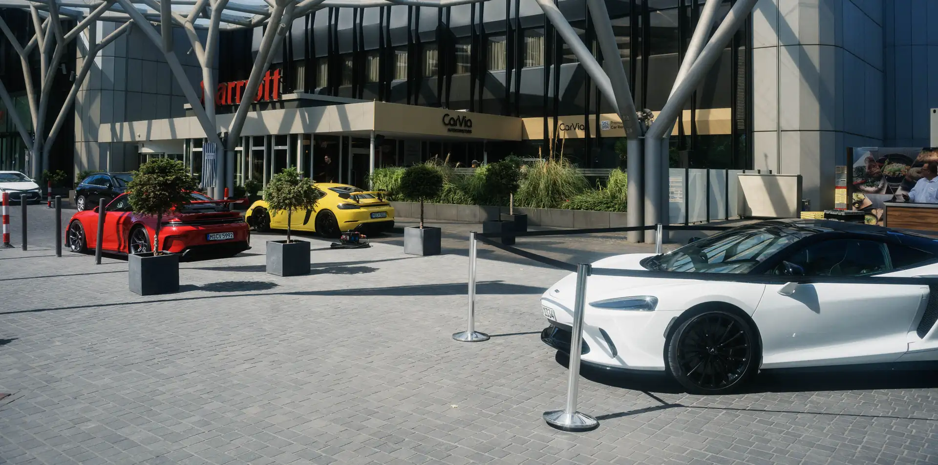 An image of a couple of rental cars in front of the Marriott Hotel Messe Frankfurt from CarVia